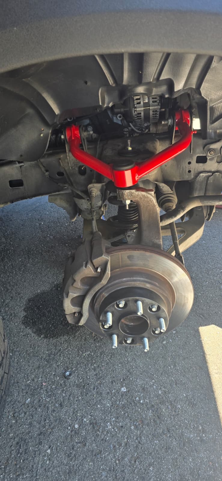 Performance suspension upgrade with red upper control arm